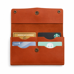 An open brown leather card holder wallet with multiple card slots containing sample credit and gift cards, shown on a plain white background.